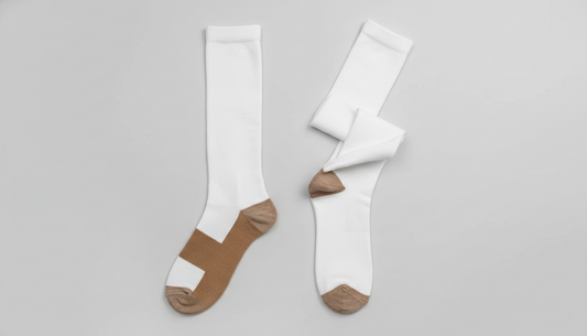 Compression socks laid flat showing elastic compression fabric and lower leg coverage